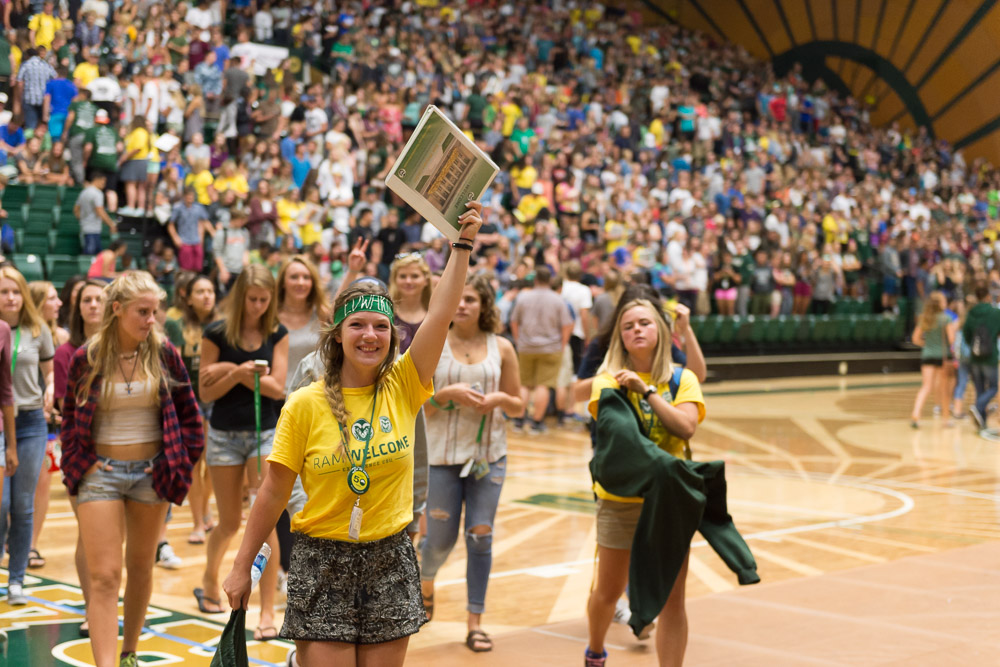 New Students participating in RAMwelcome. Students walking across the floor at Moby Arena